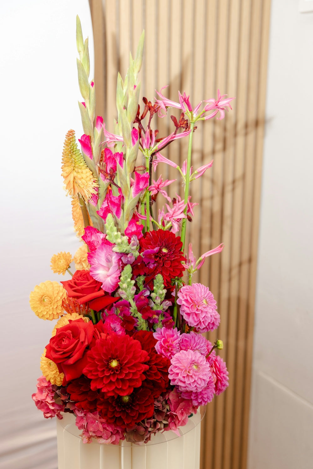 A vibrant floral arrangement with red and pink flowers.